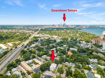 an aerial view of downtown tampa with two red arrows pointing to the location of the apartment